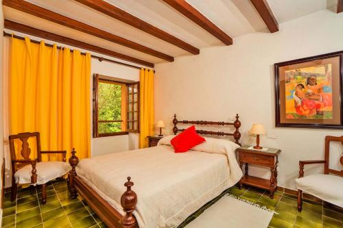 En eller flere senge i et værelse på Villa Ciutada