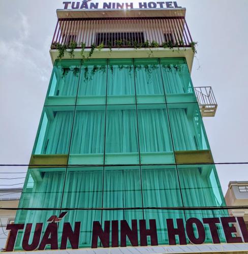 a tall green building with a sign on it at Tuấn Ninh Hotel I in Con Dao
