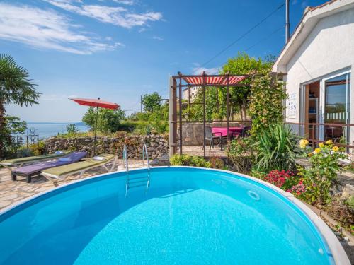 a swimming pool in the backyard of a house at Holiday Home Villa More by Interhome in Lovran