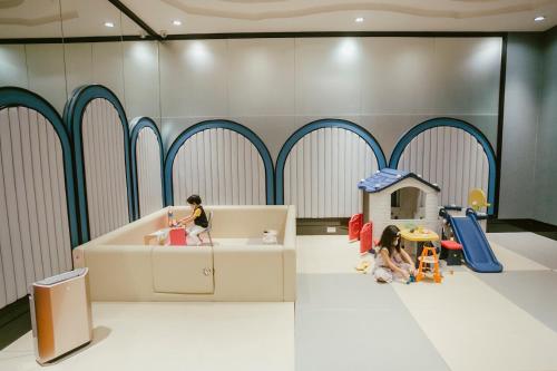 a play room with dolls and a play house at Grande Centre Point Sukhumvit 55 Thong Lo in Bangkok