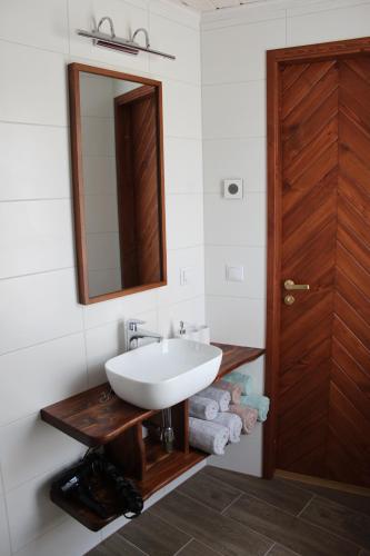 a bathroom with a white sink and a mirror at Ryytlihaus Old Town Apartement in Haapsalu
