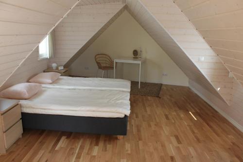 a bedroom with a bed in a attic at Ryytlihaus Old Town Apartement in Haapsalu