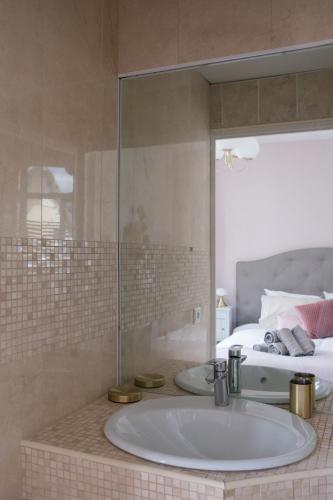 une salle de bain avec un lavabo et un lit dans l'établissement Cabourg Cosy chic Cabourg hyper-centre 4 pers, 2 bedrooms , 2 sdb, terrasse, wifi, à Cabourg
