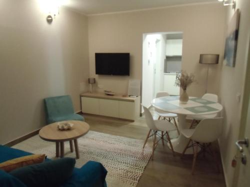 a living room with a table and a dining room at Apartments Romano in Rovinj