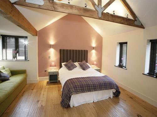 a bedroom with a large bed and a couch at Blas Gwyr in Llangennith