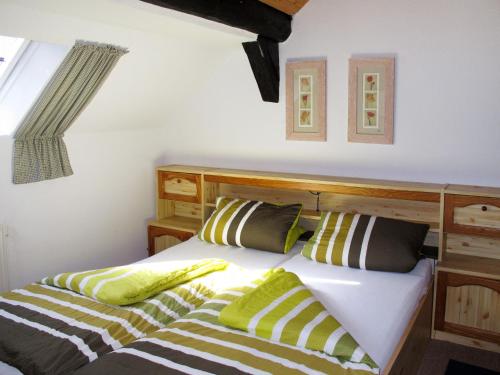 a bedroom with a bed with two pillows at Apartment Peters by Interhome in Berdumer Neue Mitteldeich