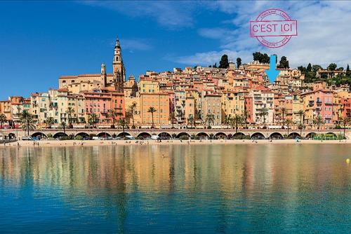 a view of a city from the water at Maison de Ville typique Mentonnaise in Menton