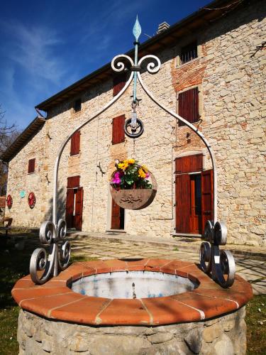 a stone building with a flower planter in front of it at La Giuncaia in Pieve Santo Stefano
