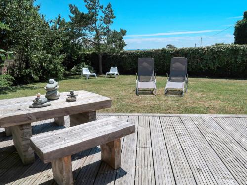 two chairs and a wooden bench on a wooden deck at Holiday Home Stereden Vor - PMN103 by Interhome in Primelin