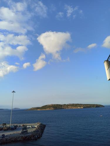 a view of a body of water with an island at Pergola Hotel in Agios Nikolaos
