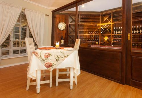 a dining room with a table with a candle on it at Shandon Lodge Guest House & Spa in Nelspruit