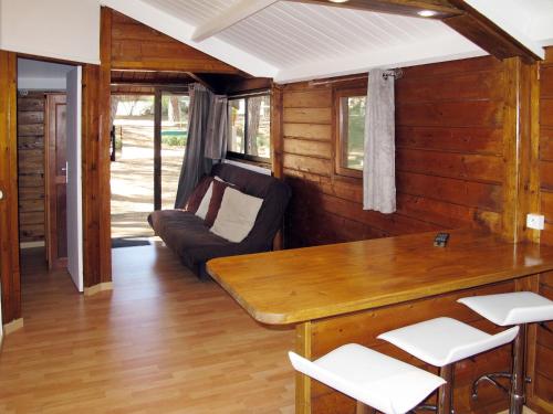 a living room with a table and a couch at Holiday Home Tramariccia-3 by Interhome in Calvi