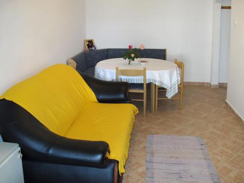 a living room with a yellow couch and a table at Holiday Home Luiza - PRC162 by Interhome in Vabriga