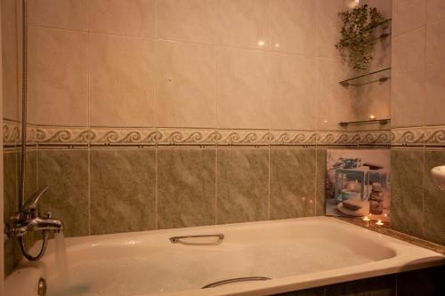 eine Badewanne im Bad mit Spiegel in der Unterkunft TuristiQA - Piso C Arenal 20 2º VUT-CO-01678 in Ferrol