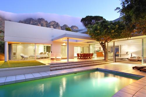 a house with a swimming pool in front of it at Lion's View Villa & Apartment in Cape Town