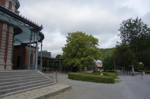 a building with a set of stairs next to a park at Gîtes le second à Spa (gîte de 2 et de 5 personnes) in Spa