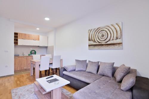 a living room with a couch and a table at Apartment White Bear in Zlatibor