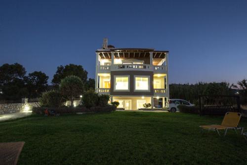 a large house with a lawn in front of it at Vasso Apartments 3 in Kissamos