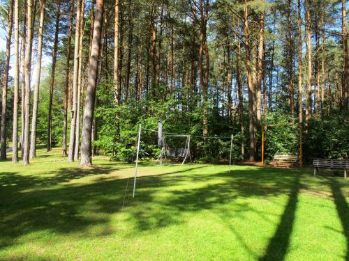 a park with a net in the middle of a field at Holiday Home Waldhäuser-1 by Interhome in Himmelpfort