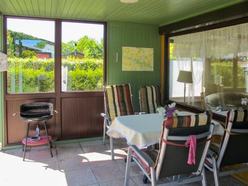a dining room with a table and chairs at Holiday Home Am Walde-2 by Interhome in Dobbertin
