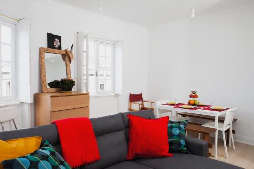a living room with a couch and a table at Avenida Central Viana - City and River Apartment in Viana do Castelo