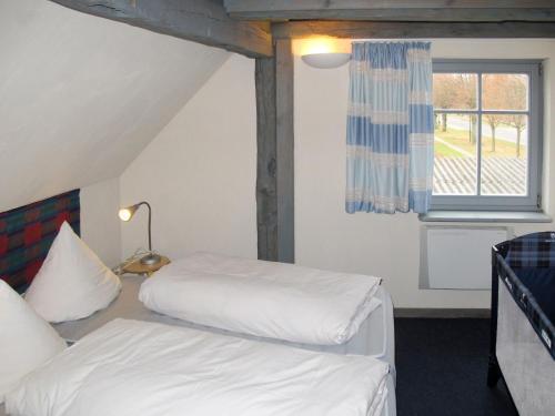 a bedroom with two beds and a window at Holiday Home Kapitänshaus Leo by Interhome in Leopoldshagen