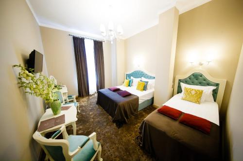 Postel nebo postele na pokoji v ubytování Grand Hotel Traian