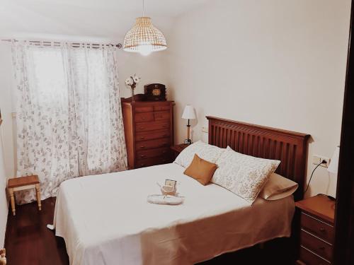A bed or beds in a room at Ático al lado del mar,en las rías baixas
