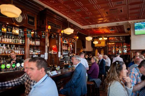 a group of people sitting at a bar at Thirteen On The Green - Eyre Square in Galway
