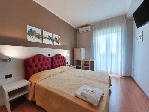 Giường trong phòng chung tại Hotel Il Quadrifoglio