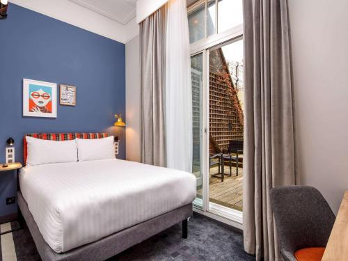 Ένα ή περισσότερα κρεβάτια σε δωμάτιο στο ibis Styles London Gloucester Road