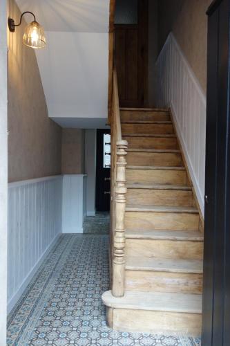 a staircase in a house with a wooden stair case at Gîtes le second à Spa (gîte de 2 et de 5 personnes) in Spa