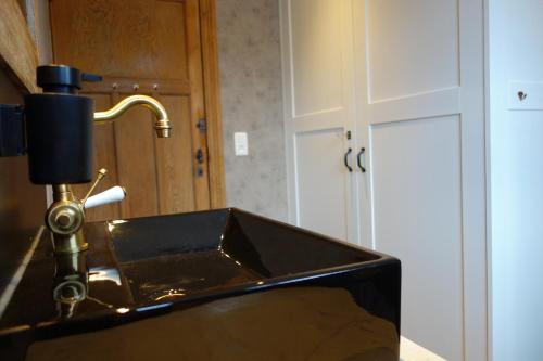 a bathroom sink with a faucet in a bathroom at Gîtes le second à Spa (gîte de 2 et de 5 personnes) in Spa