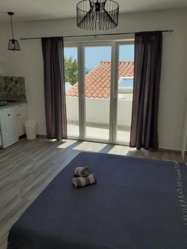 a pair of slippers sitting on a blue blanket in a room at Studio Ela in Baška Voda