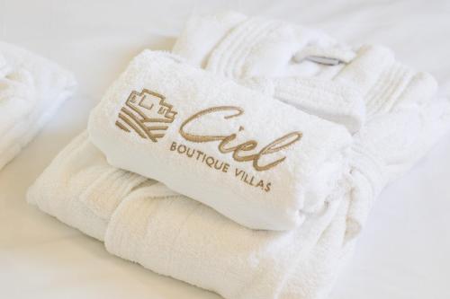 a white towel with the word fed on it at CIEL BOUTIQUE VILLAS in Afiartis