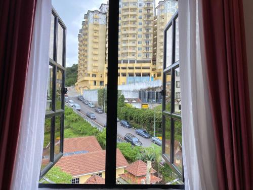 a view of a city street from a window at Hotel Rainbow in Cameron Highlands