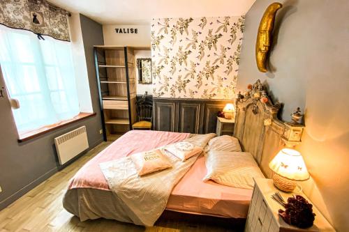 a bedroom with a bed in a room with a window at Les gites de Marie in Boulogne-sur-Mer