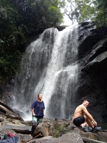two men standing in front of a waterfall at Evergreen Villa - Sinharaja in Deniyaya