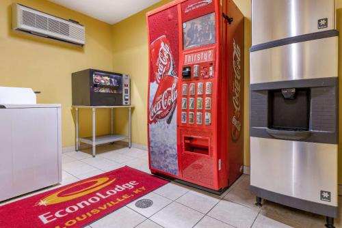 a coca cola machine in a room with a television at Econo Lodge Louisville Airport in Louisville
