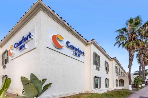 a white building with a c company sign on it at Comfort Inn San Diego Old Town in San Diego