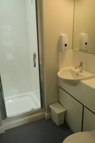 a bathroom with a toilet and a sink and a shower at FSC Preston Montford Hostel in Shrewsbury