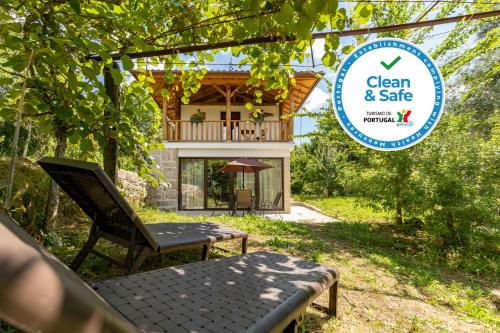 a bench and a sign in front of a house at Casa da Eira "Lavoura da Bouça - Fruta Bio" in Celorico de Basto