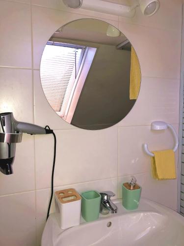 a bathroom with a sink and a mirror at MaximilianHaus in Zell an der Mosel