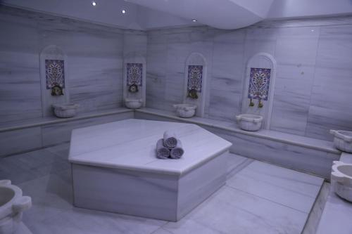 a bathroom with a bathtub, sink, and toilet at Hotel Ickale in Ankara