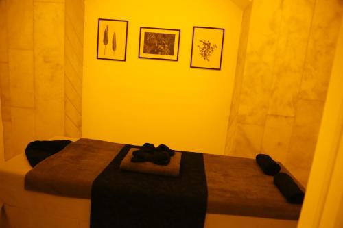 a room with a bed in a yellow room at Hotel Ickale in Ankara