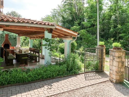 a garden with a wooden pergola and a patio at Holiday Home Paolici - LBN337 by Interhome in Nedeščina