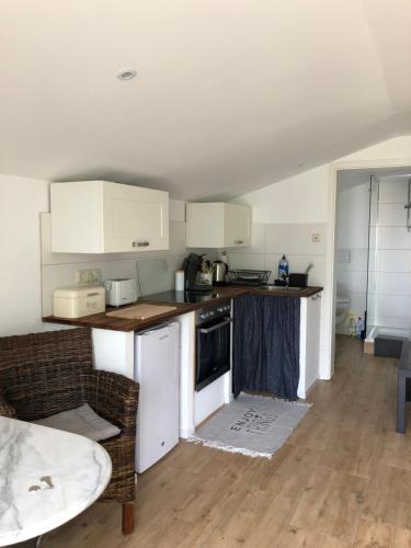 a kitchen with white cabinets and a counter top at Ferienwohnung Eiderblick in Hennstedt