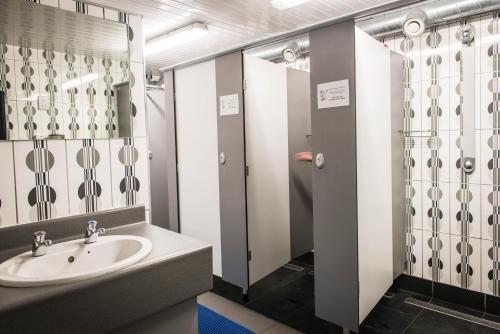 a bathroom with a sink and a shower at Sheilas Tourist Hostel in Cork