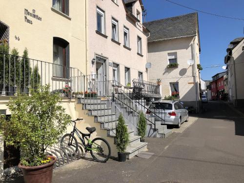 a bike parked next to a building with stairs at MaximilianHaus in Zell an der Mosel