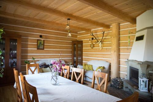 a dining room with a table and a fireplace at Śmietanówka Agroturystyka in Krzczonów